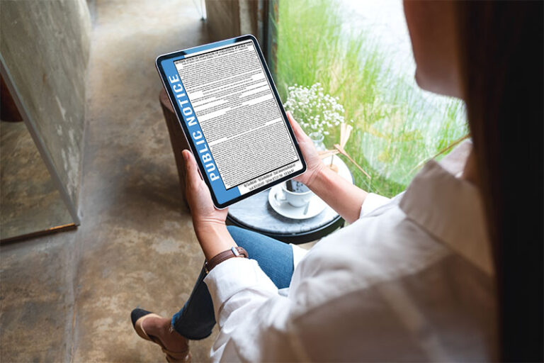 place legal ads in newspaper or online person reading a legal ad public notice ad on a tablet device