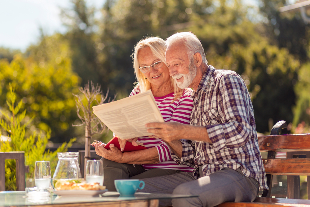 Older couple reading the newspaper reaching a diverse audience is on of the benefits of Run of Paper Advertising 