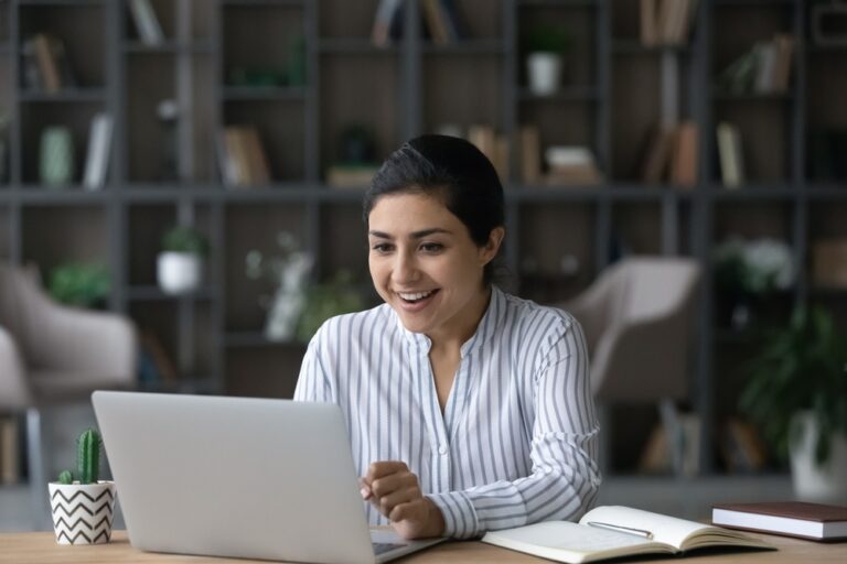 smiling person sitting at a desk who realized they could placea notice for bid with my classified ads and have it go in multiple publications reducing their work