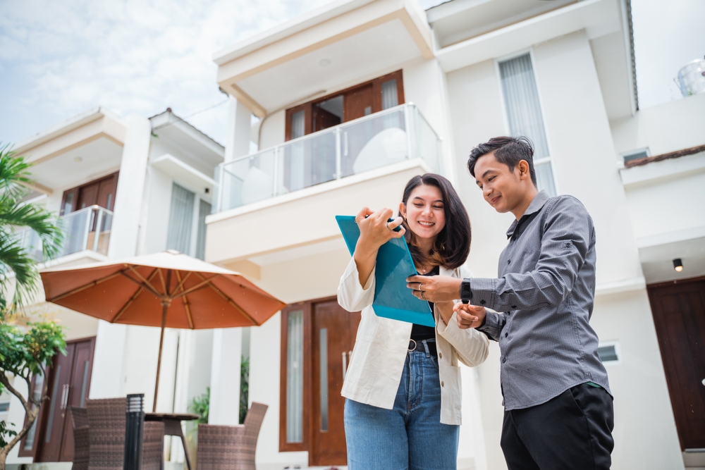 Real estate agent showing a buyer information about a home. Effectively advertise your Real Estate listing online or in print 