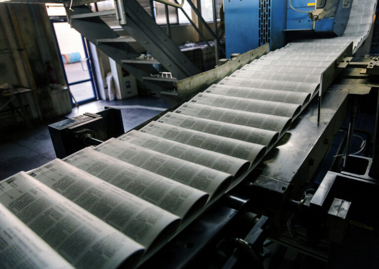 newspaper being printed on a printing press place run of paper advertising in credible publications